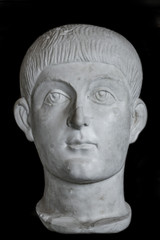 Fototapeta na wymiar Statue of young Roman Noble boy at black background, Rome, Italy