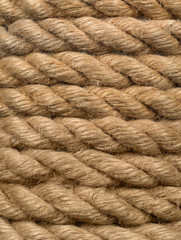Fototapeta na wymiar Vertical close-up of an old worn boat cable as background.