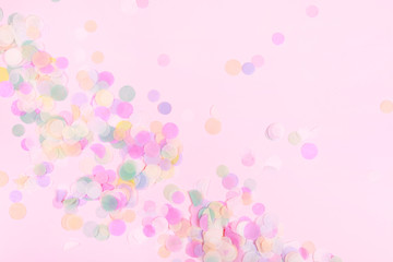 Vibrant confetti on pastel pink background