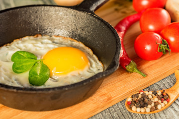 Fried eggs in a frying pan. Rustic breakfast