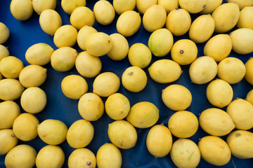 Yellow Juicy Lemons on Market Stall For Sale