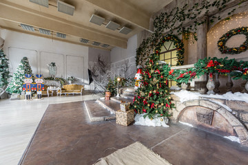 the scenery of the Studio or theater. Entrance in an old architecture with staircase and columns. Christmas decoration with garlands and fir branches
