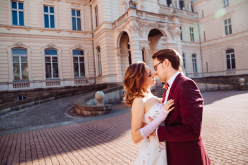 Fototapeta premium gentle embrace of the bride and groom in a sunny day near the pa
