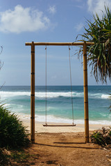 Swing on tropical beach. Ocean in Bali. Summer vacation