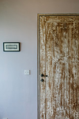 Old wooden door and white wall in luxury interior