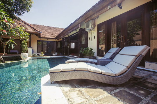 Private swimming pool near luxury villa. Sunny summer vacation