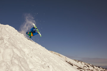 snowboard man have fun and jumping in snow. Winter sport holiday mountains sky resort