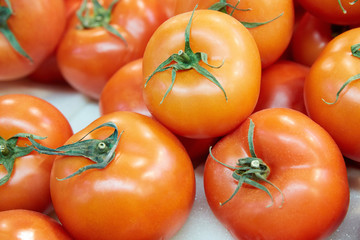 A few red tomatoes with green petioles. 