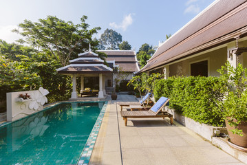 Fototapeta premium Private swimming pool near luxury villa. Sunny summer travel vacation