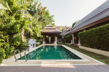 Private swimming pool near luxury villa. Sunny summer travel vacation