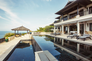 Fototapeta na wymiar Swimming pool with sea view in luxury villa interior