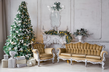 Christmas morning . classic apartments with a white fireplace, decorated fir tree, sofa, large windows and chandelier.
