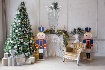 Christmas morning . classic apartments with a white fireplace, decorated fir tree, sofa, large windows and chandelier.