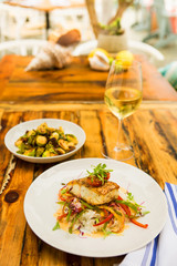 Creole sea bass and grilled brussels sprouts with a glass of chardonnay, Rumfish & Vino, Ventura, California