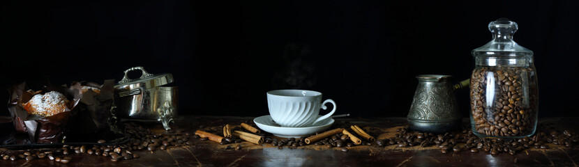 Panorama with a Cup of coffee, coffee beans and muffins