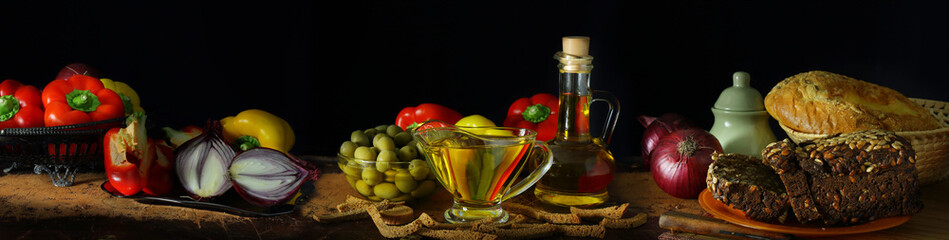 Panorama with olive oil, vegetables and bread