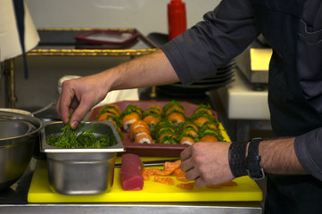 Preparing Japanese Sushi with salmon and seaweed
