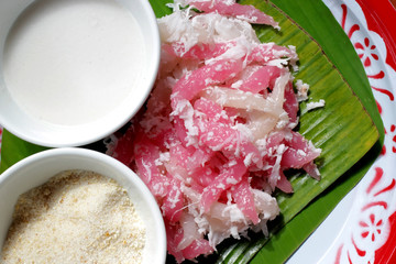 Thai dessert sweet sticky morsels with grated coconut and sugar