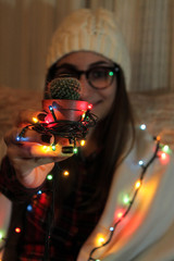 Girl holding cactus with Christmas lights