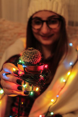 Happy girl with decorated cactus