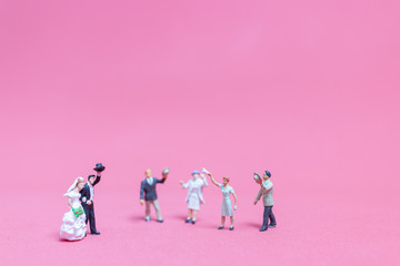 Bride and groom on pink background ,