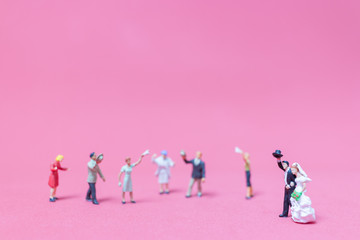 Bride and groom on pink background ,