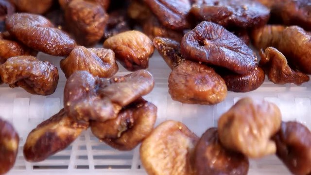 Dried figs on conveyor belt. Drying on industrial microw