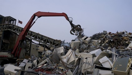 scrapyard recycling center creates beautiful manmade landscapes from waste metal using cranes with claws 