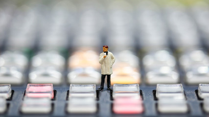 Obraz premium Miniature people : journalists , cameraman ,Videographer at work shooting on switcher control of Television Broadcast,color buttons