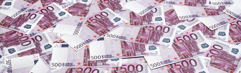 Money background consisting of purple five hundred Euro bills spread across the screen. Symbolic...