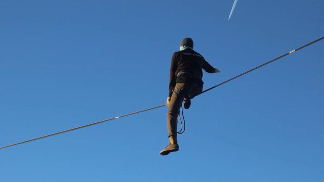 Ropewalker poised over the abyss.