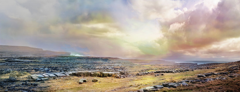 Panoramic Irish landscape with stones, grass and  cloudy sky