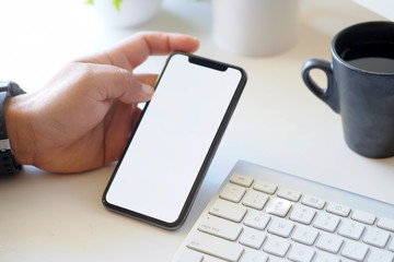 High angle shot of an unrecognizable businessman using a mobile phone at desk work.