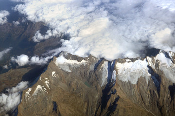 The top view of the high mountains and the clouds at their peaks