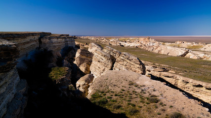 Panorama view to Aral sea from the rim of Plateau Ustyurt at sunset in Karakalpakstan, Uzbekistan