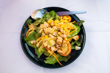 Chicken salad with tomato, corn and carrot