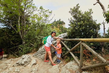 Fototapeta na wymiar woman with child tourist in the mountains of italy.