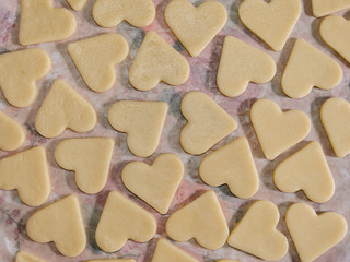 raw cookies in the shape of hearts, top view.