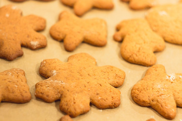 Ginger biscuits lie on a baking sheet. Cookies on baking paper. Selective focus.