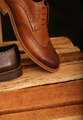 Brown Leather Shoes on Wooden Boxes