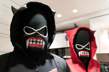 a demons mask, a couple anorak in black and red costume on devil mask