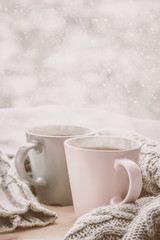 Valentine's day concept - two cups of tea in front of snow background