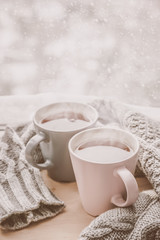 Obraz na płótnie Canvas Valentine's day concept - two cups of tea in front of snow background