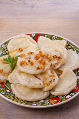 Dumplings, filled with potato and served with fried onion. Varenyky, vareniki, pierogi, pyrohy