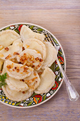 Dumplings, filled with potato and served with fried onion. Varenyky, vareniki, pierogi, pyrohy. overhead
