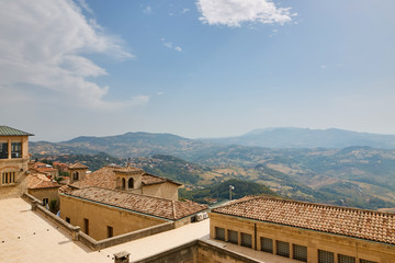Fototapeta na wymiar San marino, San Marino - July 10, 2017: View from the top of the view on houses with red roofs.