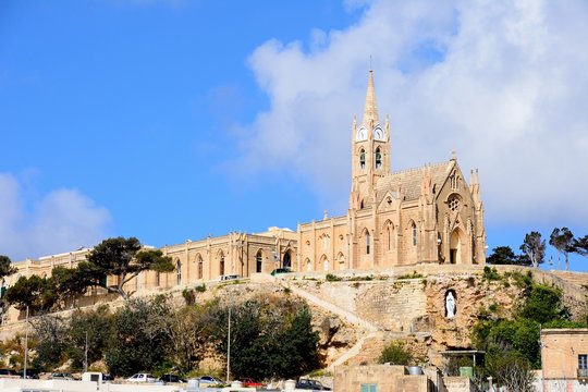 View of Our Lady of Lourdes church on the hillside, Mgarr, Gozo, Malta.