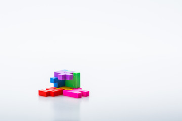 Obraz premium Colourful 3D puzzle piece isolated on white background. Concept of puzzle solving. Isolated on white background. Slightly de-focused and close-up shot. Copy space.