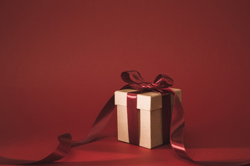 close up view of present decorated with ribbon on red