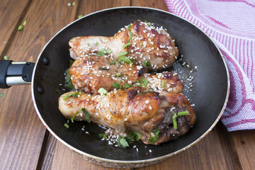 fried chicken legs in a frying pan